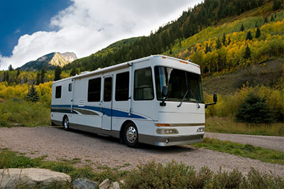 a bus driving down a dirt road